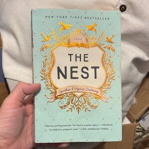 The Nest paperback book - mint green cover with gold detailing